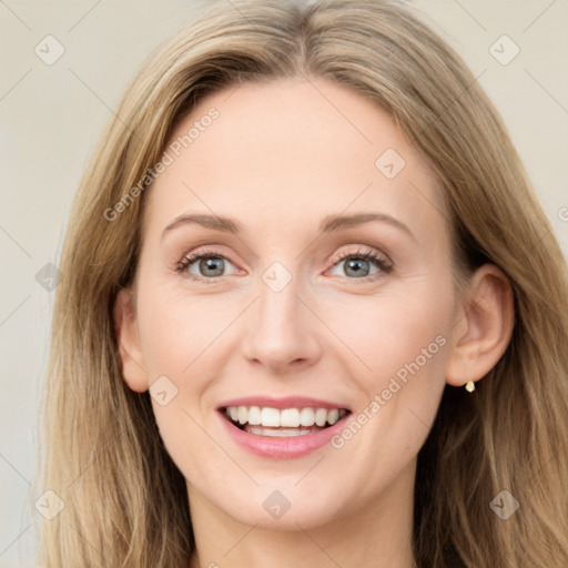 Joyful white young-adult female with long  brown hair and blue eyes