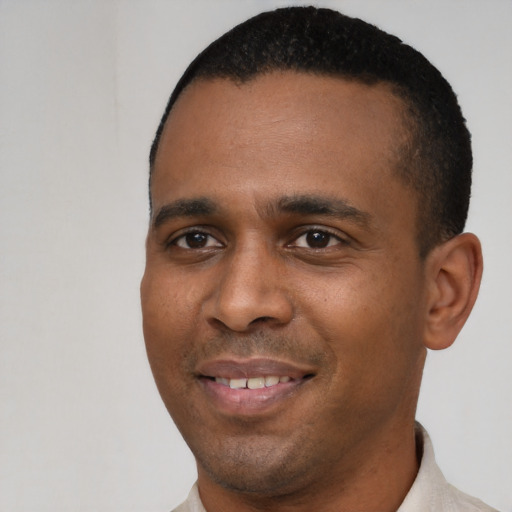 Joyful latino young-adult male with short  black hair and brown eyes