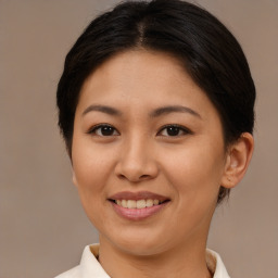 Joyful asian young-adult female with short  brown hair and brown eyes