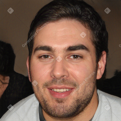 Joyful white adult male with short  black hair and brown eyes