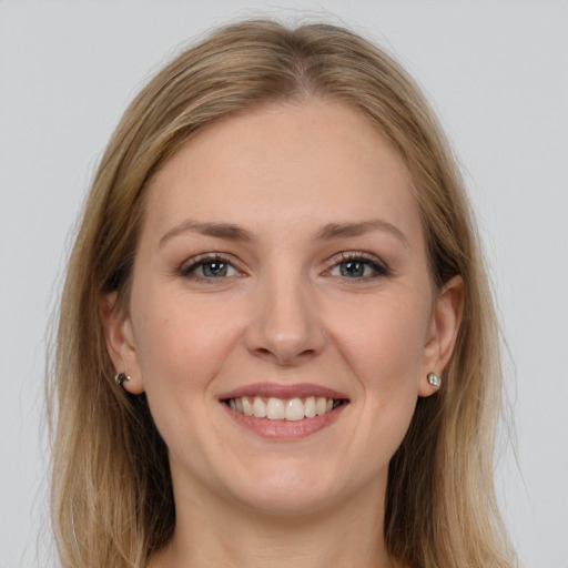 Joyful white young-adult female with long  brown hair and grey eyes