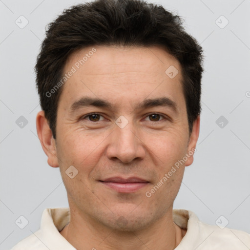 Joyful white adult male with short  brown hair and brown eyes