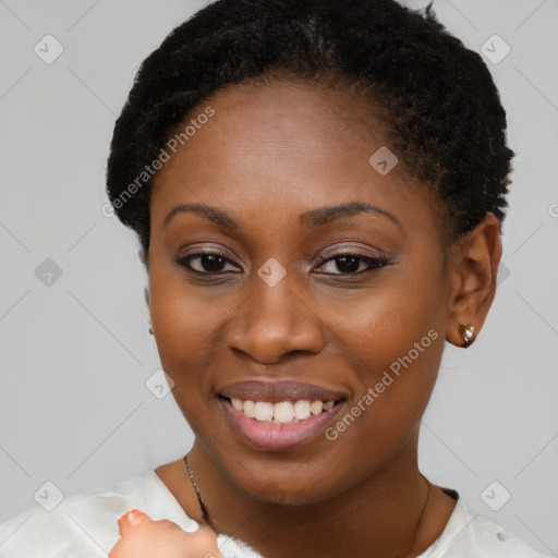 Joyful black young-adult female with short  brown hair and brown eyes