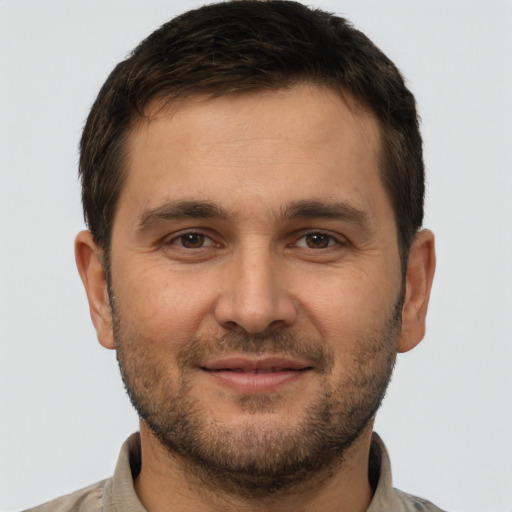 Joyful white young-adult male with short  brown hair and brown eyes