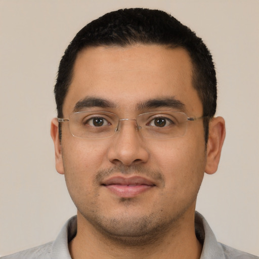 Joyful latino young-adult male with short  black hair and brown eyes