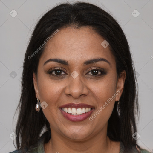 Joyful black young-adult female with long  brown hair and brown eyes