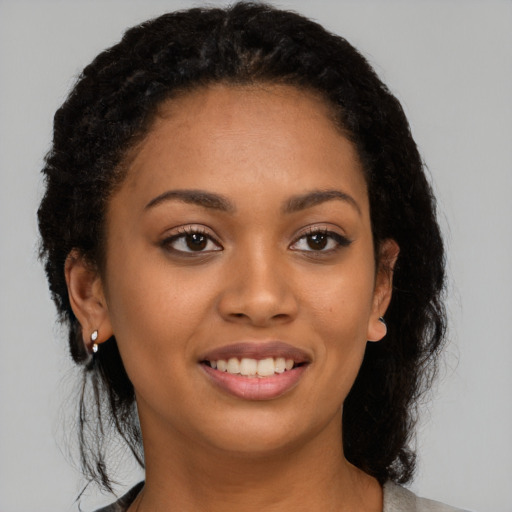 Joyful latino young-adult female with long  brown hair and brown eyes