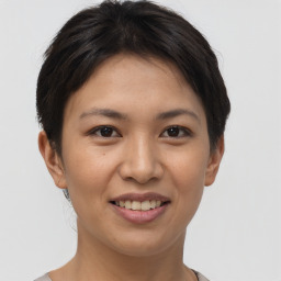 Joyful asian young-adult female with short  brown hair and brown eyes