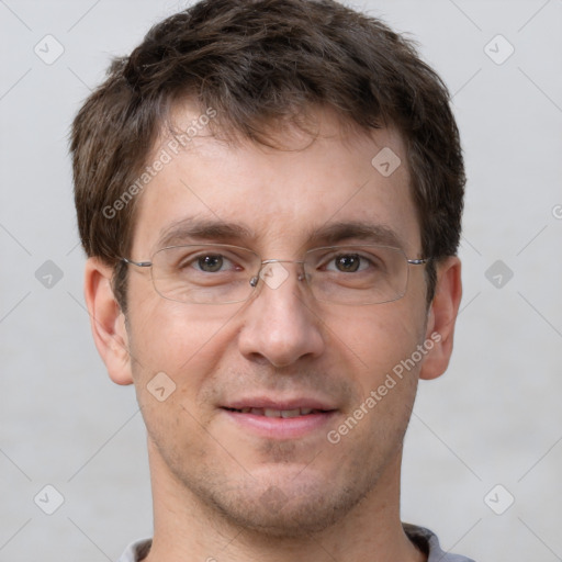 Joyful white adult male with short  brown hair and grey eyes