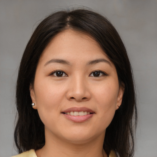Joyful asian young-adult female with medium  brown hair and brown eyes