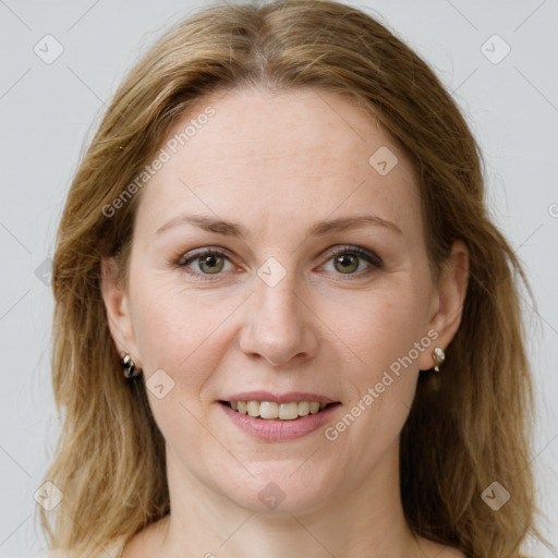 Joyful white adult female with long  brown hair and green eyes