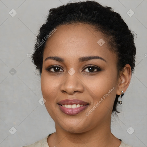 Joyful black young-adult female with short  brown hair and brown eyes