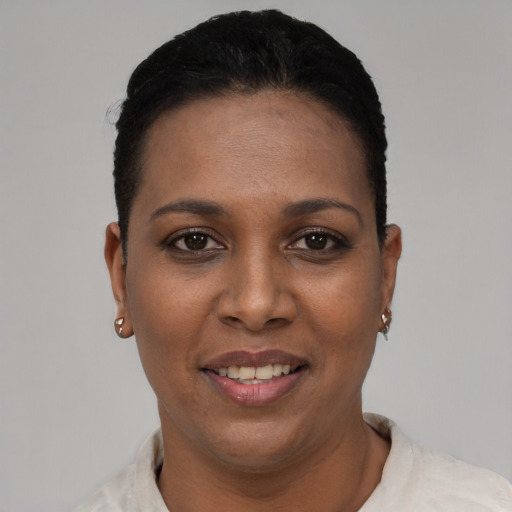 Joyful black young-adult female with short  black hair and brown eyes