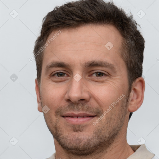 Joyful white adult male with short  brown hair and brown eyes