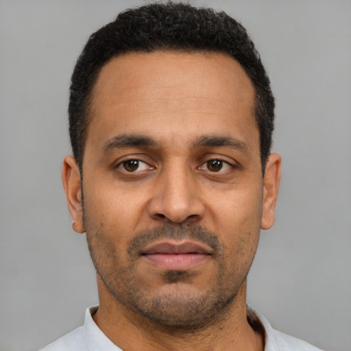 Neutral latino adult male with short  black hair and brown eyes