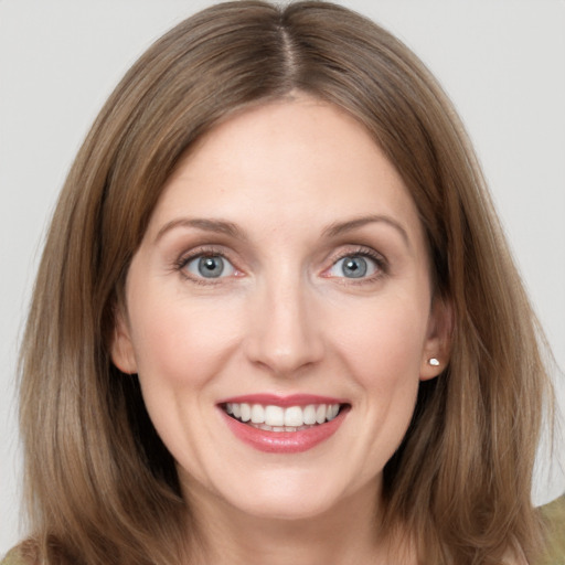 Joyful white young-adult female with medium  brown hair and grey eyes