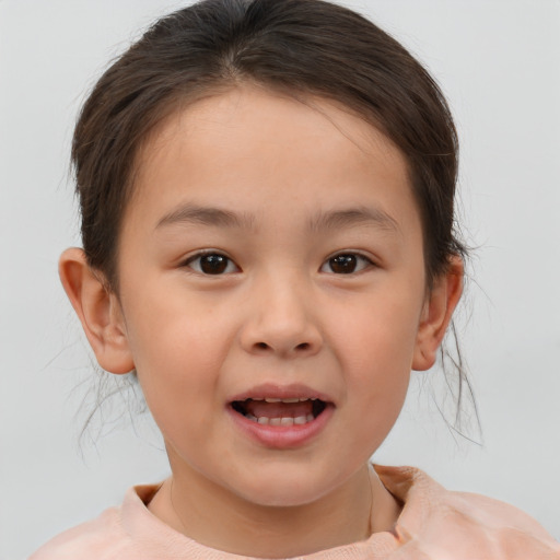 Joyful white child female with short  brown hair and brown eyes