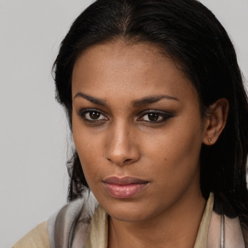 Neutral black young-adult female with long  brown hair and brown eyes