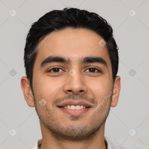 Joyful latino young-adult male with short  black hair and brown eyes