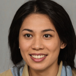 Joyful asian young-adult female with medium  brown hair and brown eyes