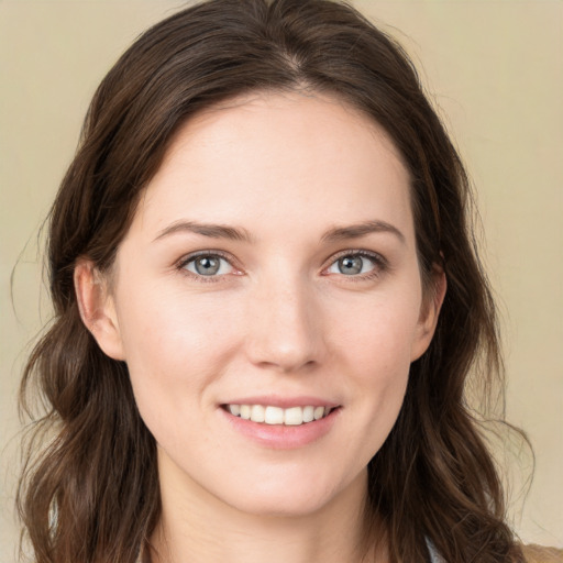 Joyful white young-adult female with long  brown hair and green eyes