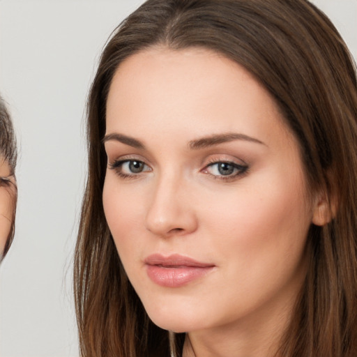 Neutral white young-adult female with long  brown hair and brown eyes