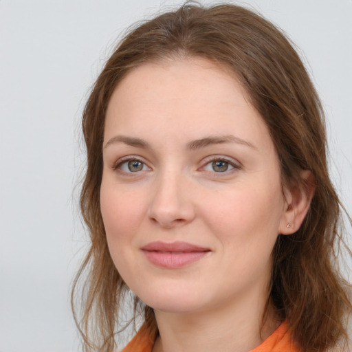 Joyful white young-adult female with long  brown hair and blue eyes