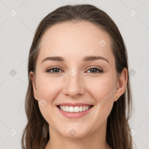 Joyful white young-adult female with long  brown hair and grey eyes