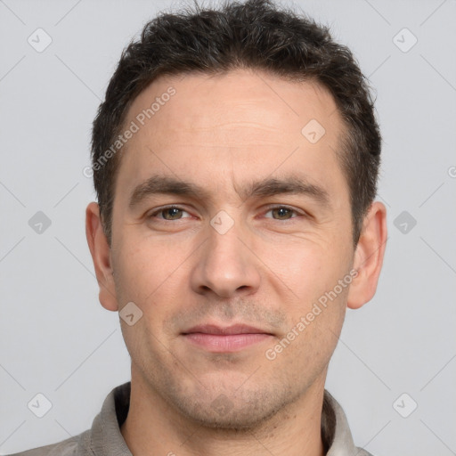 Joyful white adult male with short  brown hair and brown eyes