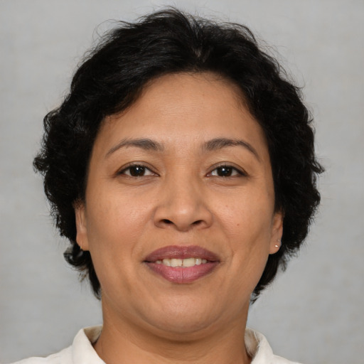 Joyful latino adult female with short  brown hair and brown eyes