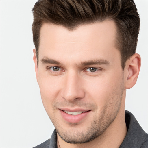 Joyful white young-adult male with short  brown hair and brown eyes