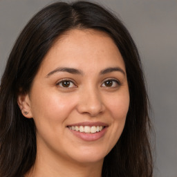 Joyful white young-adult female with long  brown hair and brown eyes