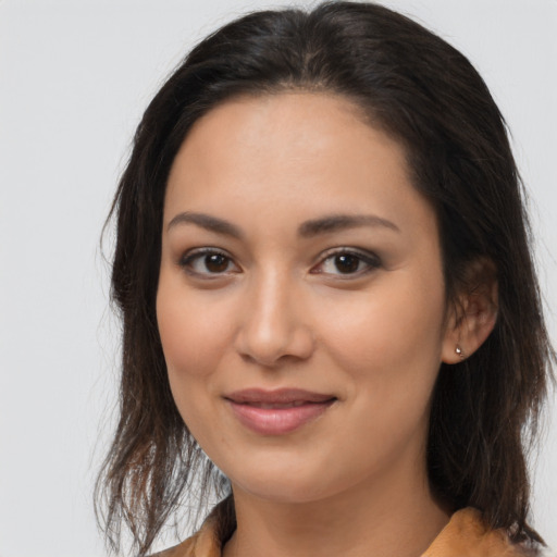 Joyful latino young-adult female with medium  brown hair and brown eyes