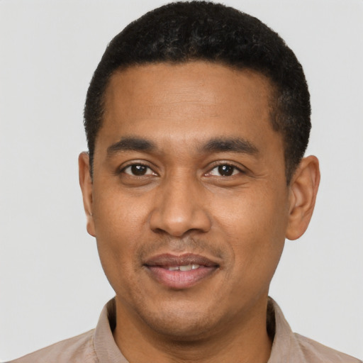 Joyful latino young-adult male with short  black hair and brown eyes