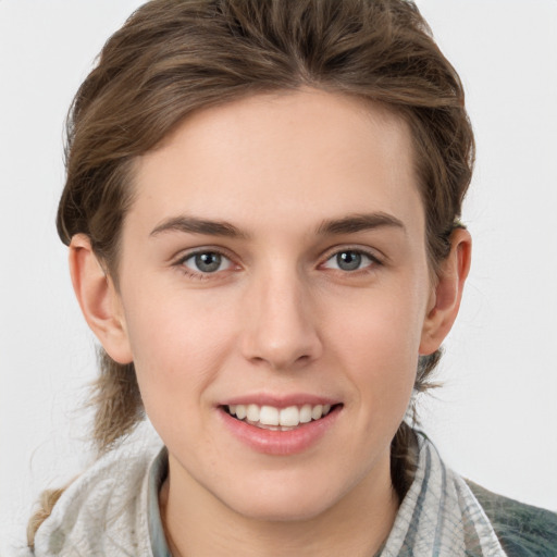 Joyful white young-adult female with medium  brown hair and grey eyes