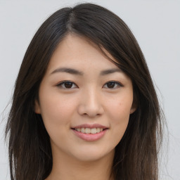 Joyful asian young-adult female with long  brown hair and brown eyes