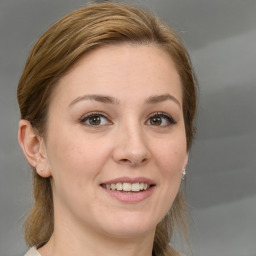 Joyful white young-adult female with medium  brown hair and blue eyes