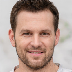 Joyful white adult male with short  brown hair and brown eyes