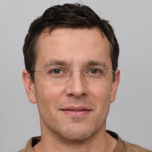 Joyful white adult male with short  brown hair and brown eyes