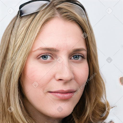 Joyful white young-adult female with long  brown hair and blue eyes