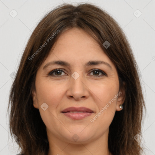 Joyful white adult female with long  brown hair and brown eyes