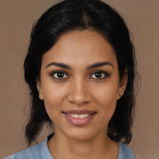 Joyful black young-adult female with medium  black hair and brown eyes