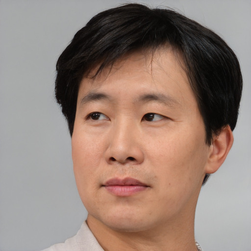 Neutral asian adult male with short  black hair and brown eyes