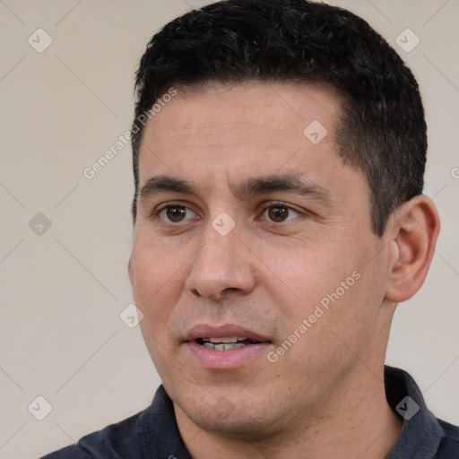 Joyful white young-adult male with short  black hair and brown eyes