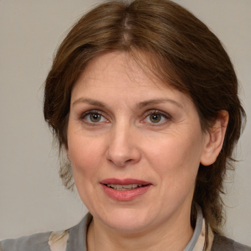 Joyful white adult female with medium  brown hair and brown eyes