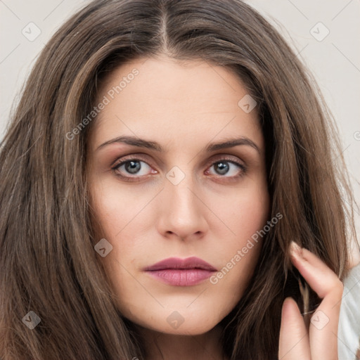 Neutral white young-adult female with long  brown hair and brown eyes