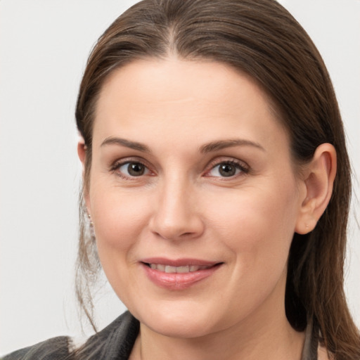 Joyful white young-adult female with long  brown hair and brown eyes