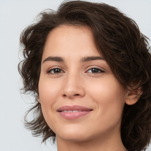 Joyful white young-adult female with medium  brown hair and brown eyes