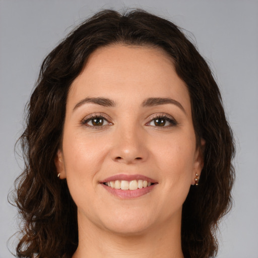 Joyful white young-adult female with medium  brown hair and brown eyes