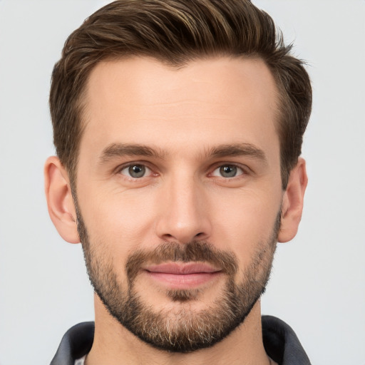 Joyful white young-adult male with short  brown hair and brown eyes